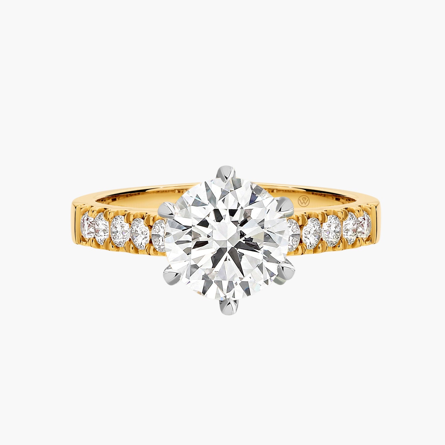 Gold ring with a large diamond and smaller diamonds on the band against a white background