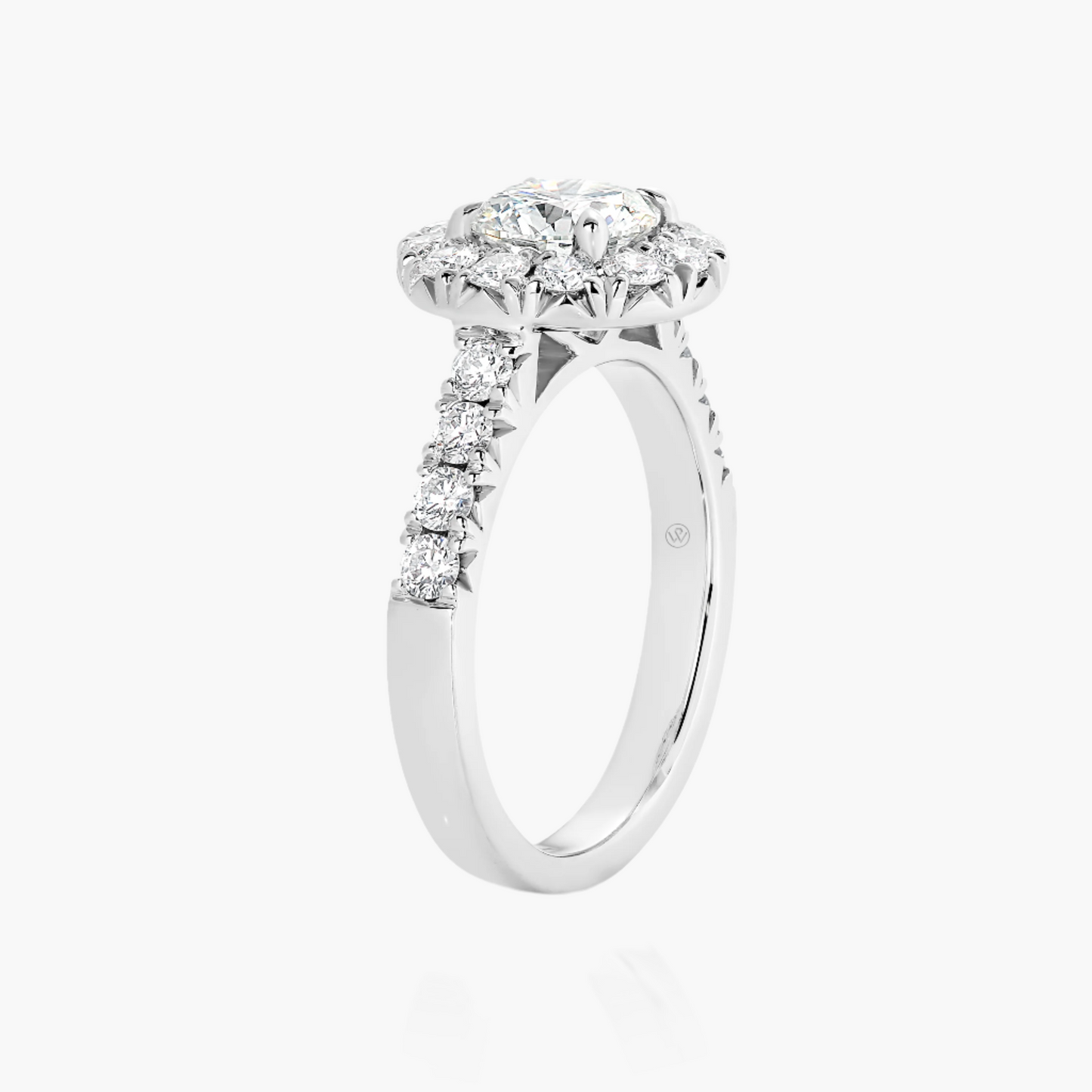Diamond ring with a halo setting on a white background