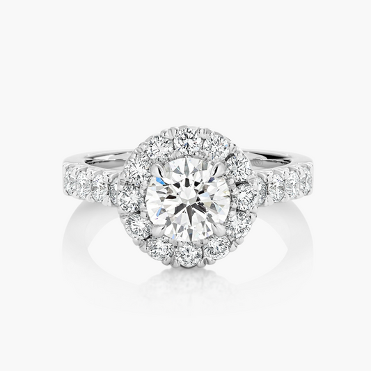 Diamond ring with a halo on a white background