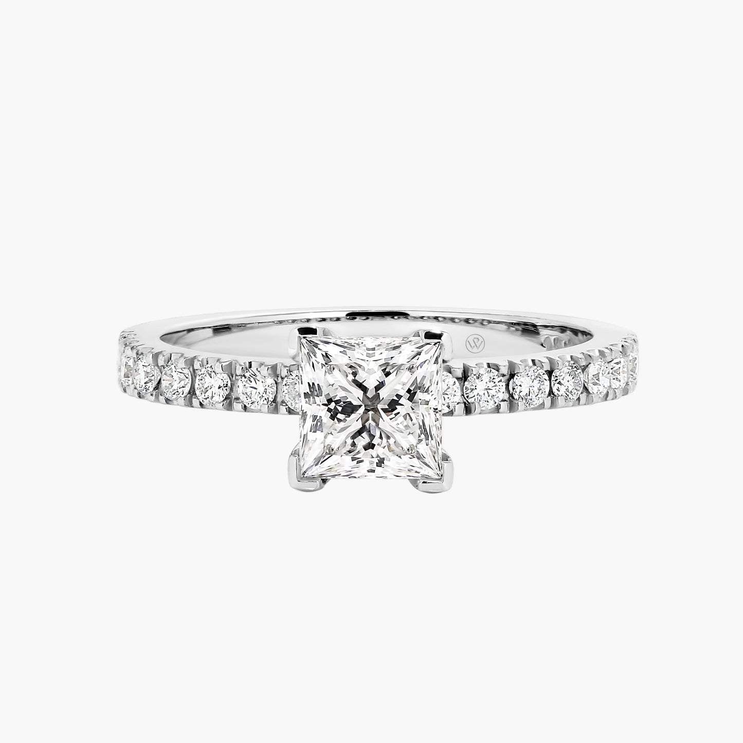Diamond ring with a central square-cut gemstone and smaller round stones on a white background