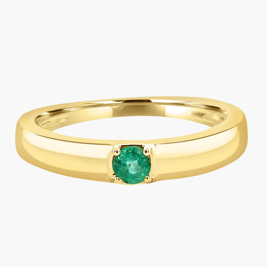 Gold ring with a green gemstone on a white background