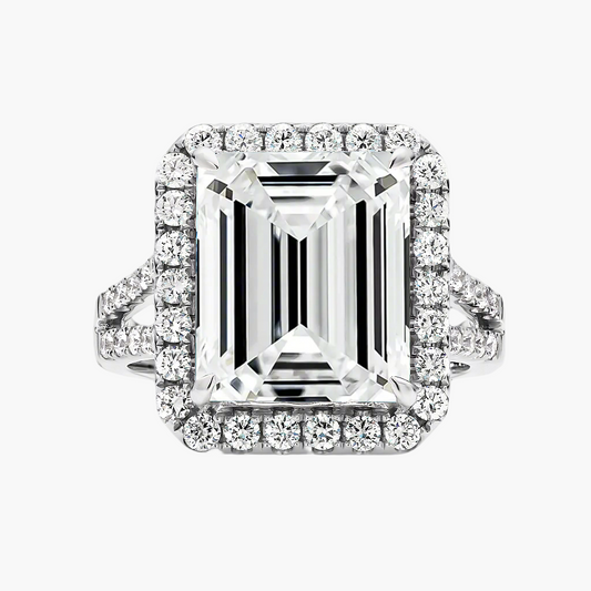 Diamond ring with emerald-cut center stone and halo on a gray background