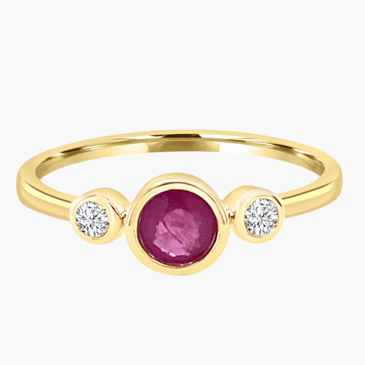 Gold ring with a central ruby and two side diamonds on a white background