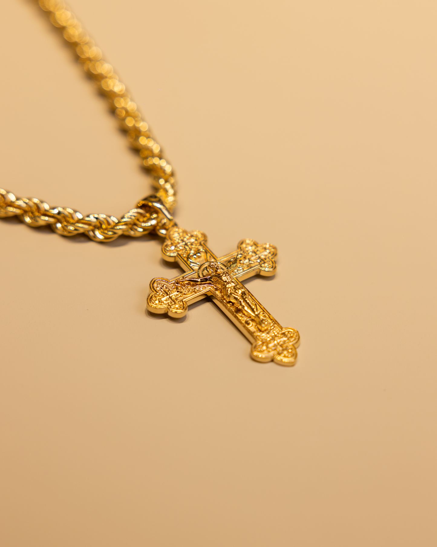 Gold rope chain with a cross pendant