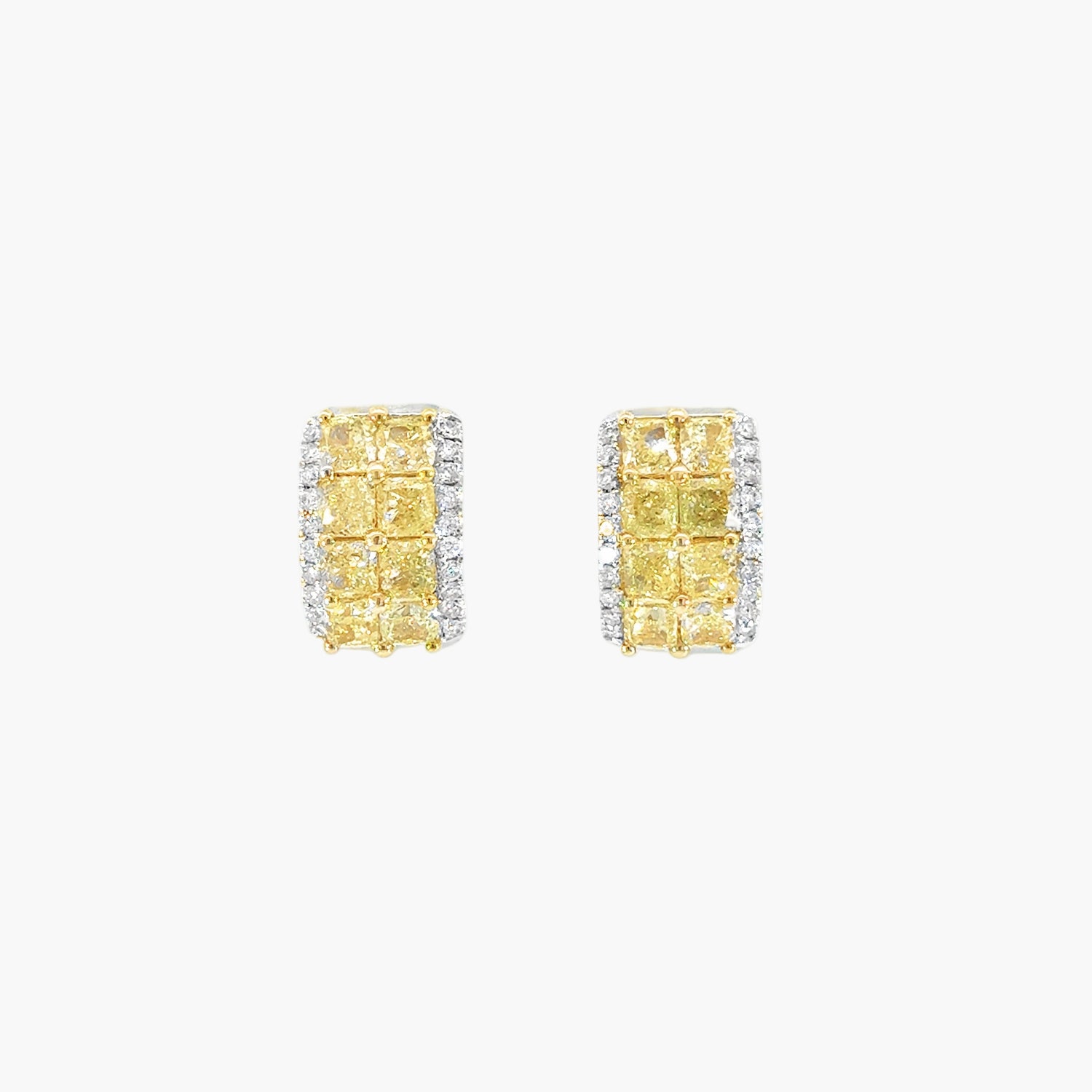 Pair of yellow gemstone earrings with diamond accents on a white background