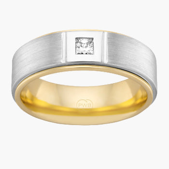 Two-tone ring with a diamond on a white background