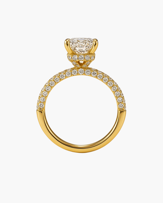 Radiant cut diamond engagement ring in 18ct yellow gold with pavé shoulders and hidden halo