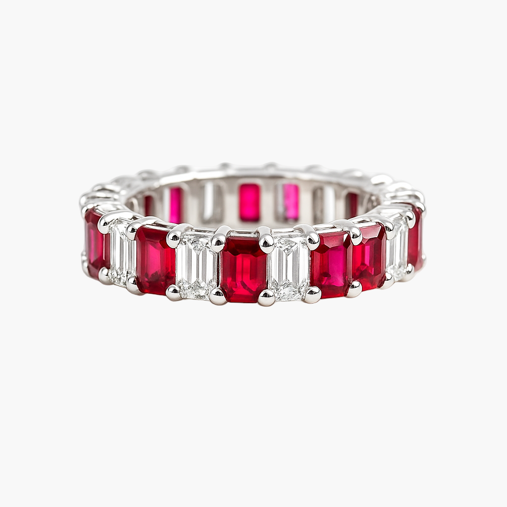 Silver ring with emerald-cut rubies on a white background