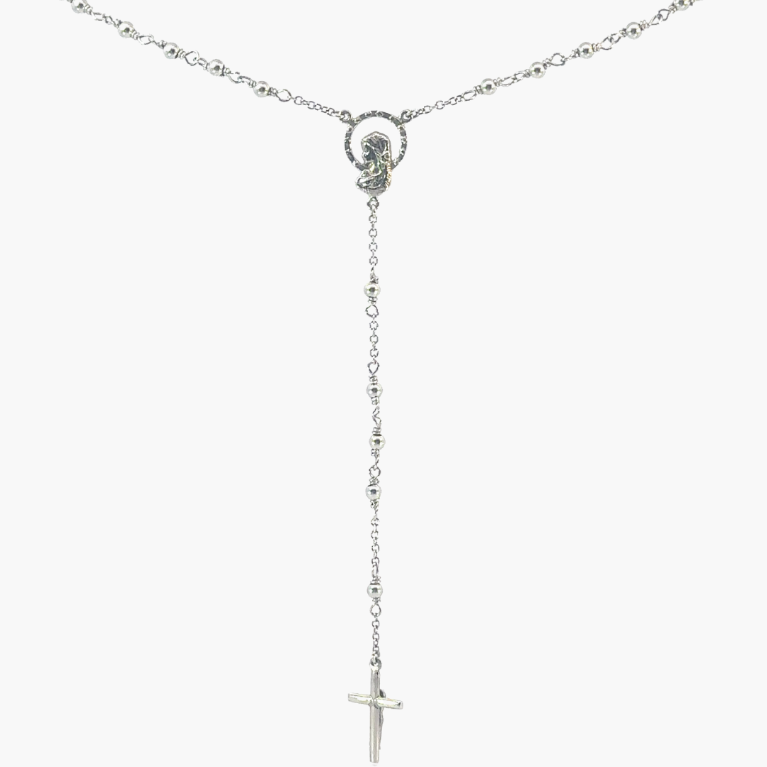 Silver rosary with a central mary and cross on a white background