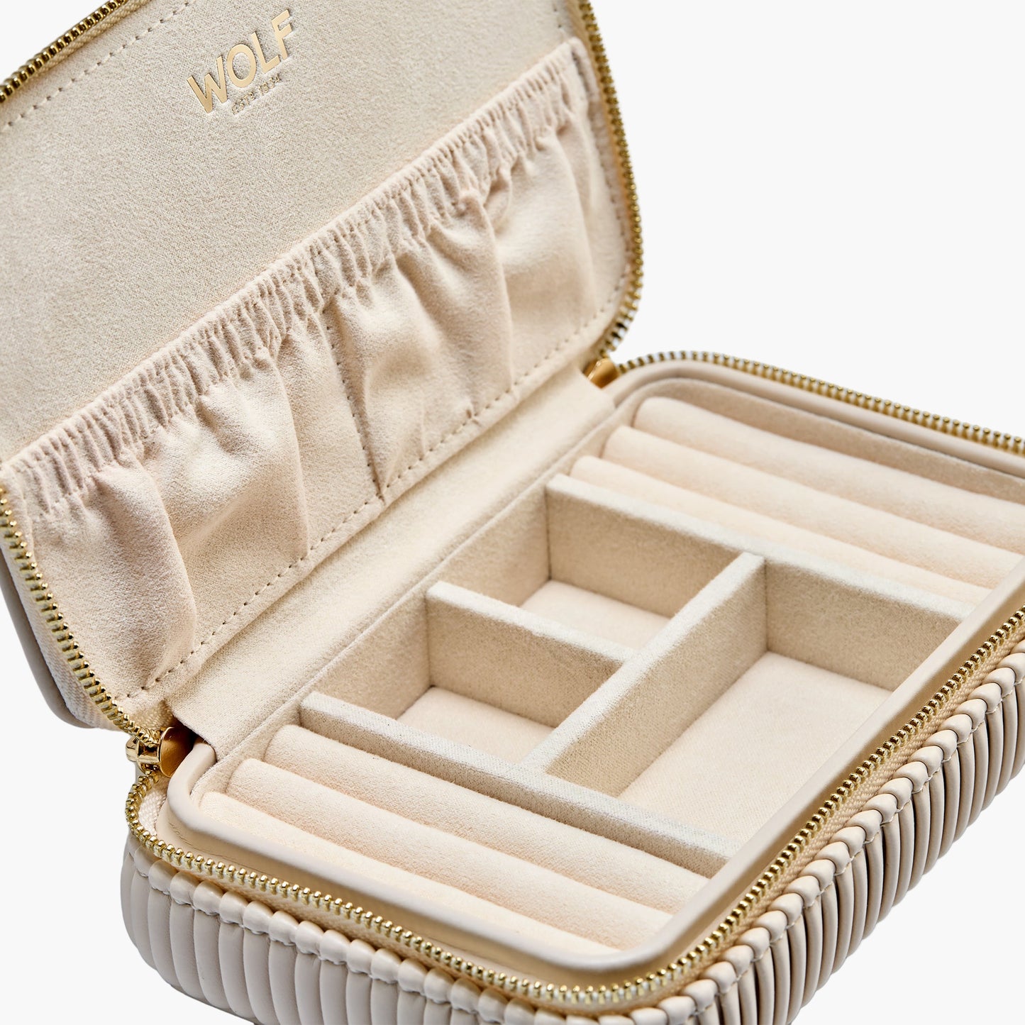 Beige jewelry case with gold zipper and interior compartments on a white background