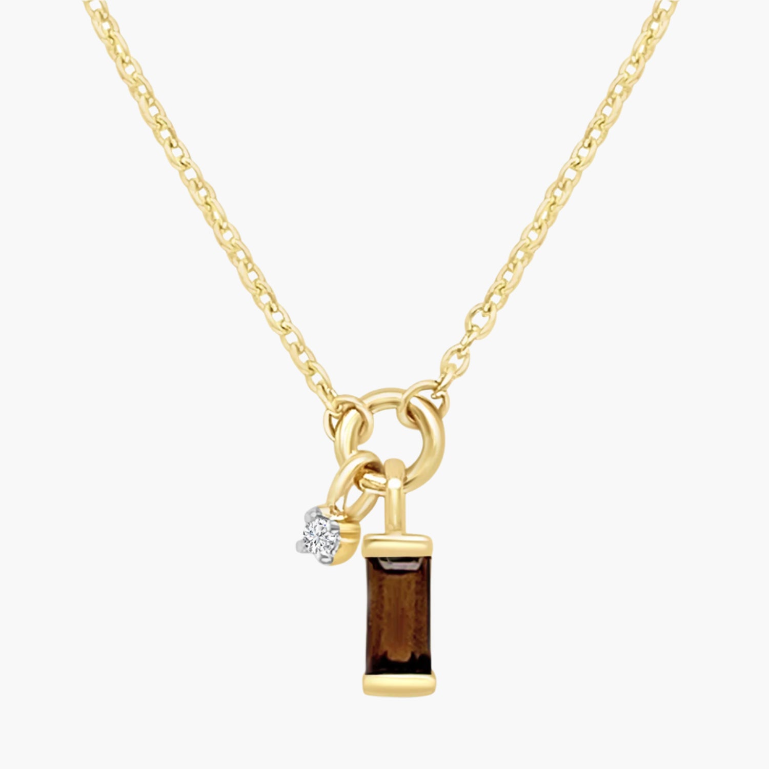 Gold necklace with a rectangular brown gemstone pendant and a small diamond charm on a white background