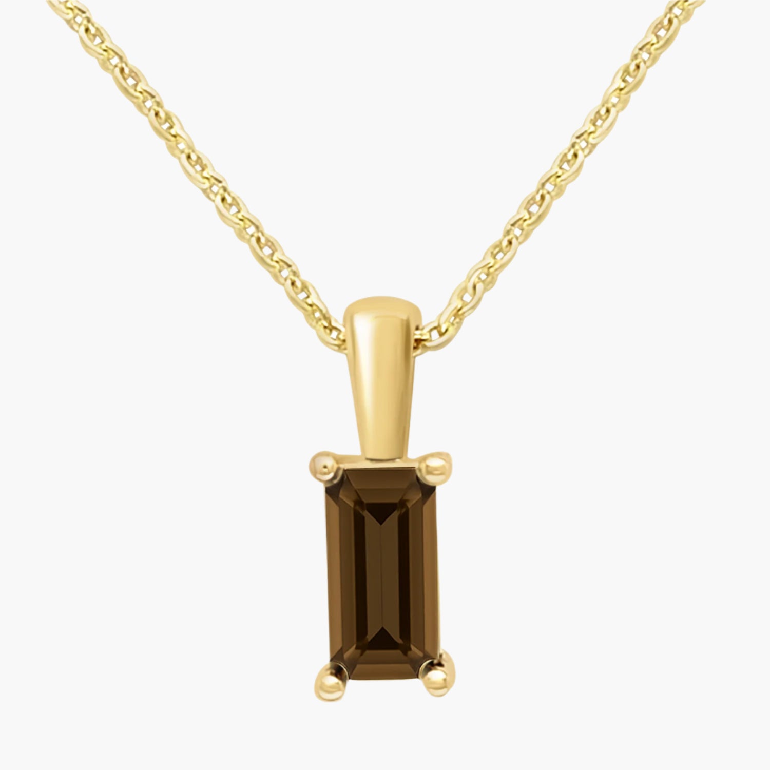 Gold pendant with a brown gemstone on a white background