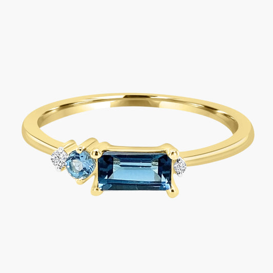 Gold ring with blue gemstones on a white background