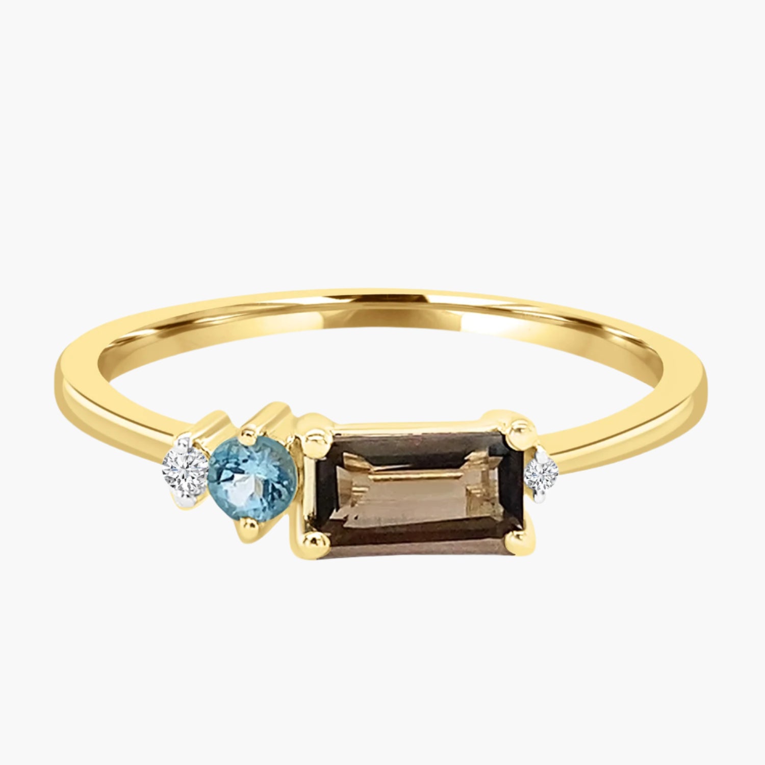 Gold ring with three gemstones on a white background