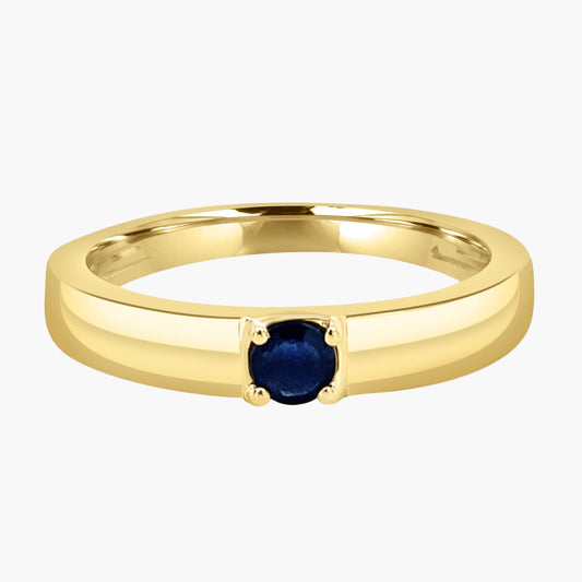 Gold ring with a blue gemstone on a white background