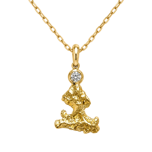 A yellow gold necklace featuring a textured, organic-shaped pendant with a small round clear gemstone at the top, suspended from a delicate gold chain against a white background.