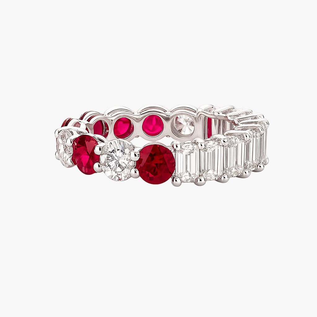 Elegant ring with red gemstones and diamond accents on a white background