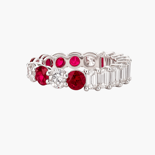 Elegant ring with red gemstones and diamond accents on a white background