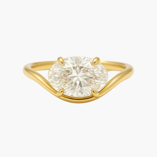 Gold ring with a large diamond on a white background