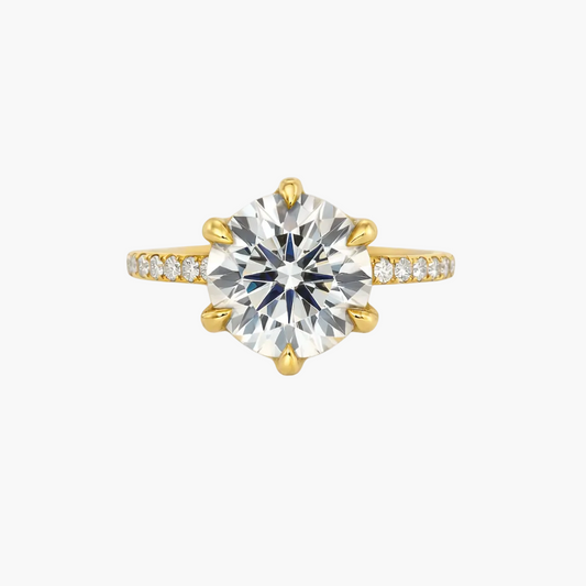 Gold ring with a large diamond on a white background