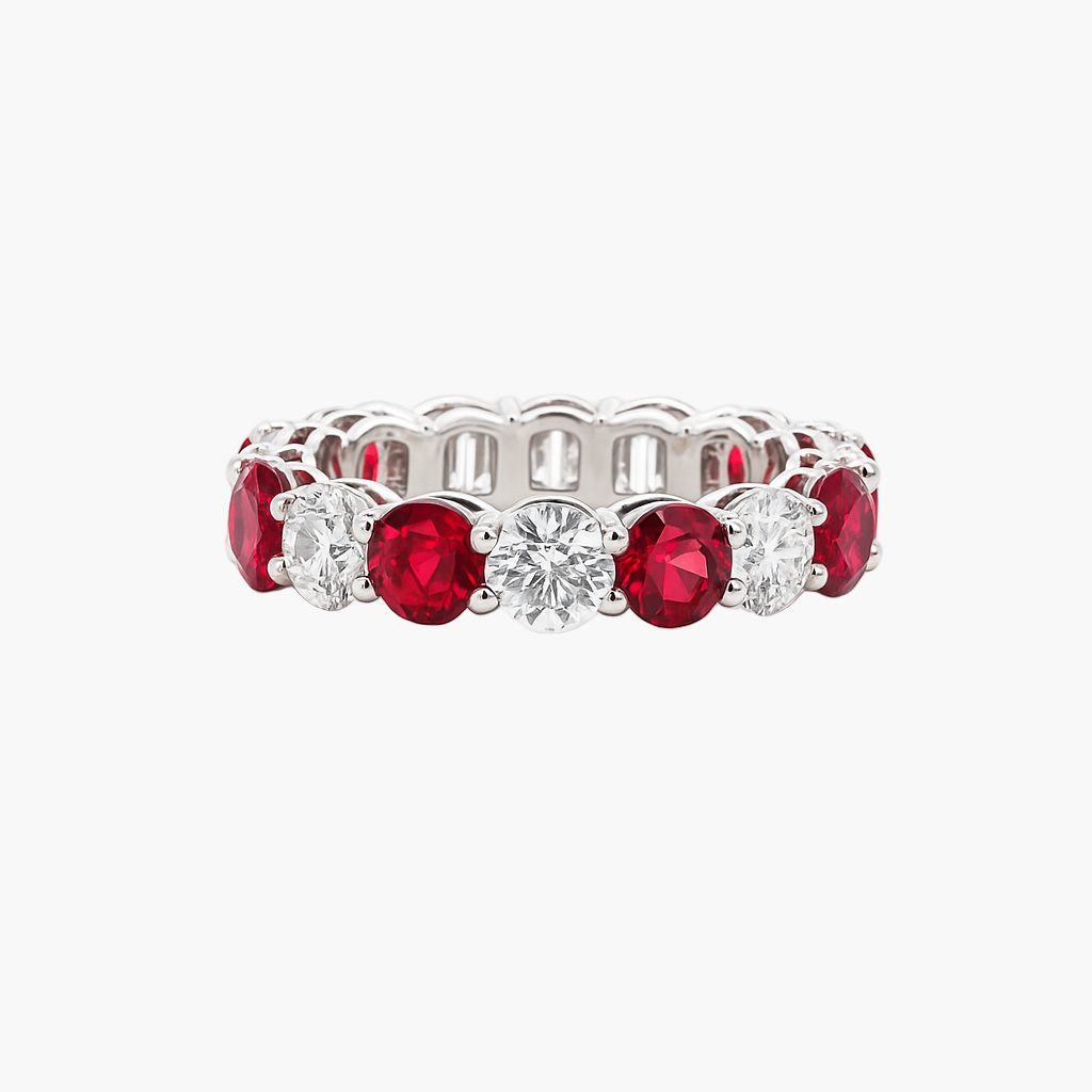 Eternity ring with red gemstones and a diamond on a white background