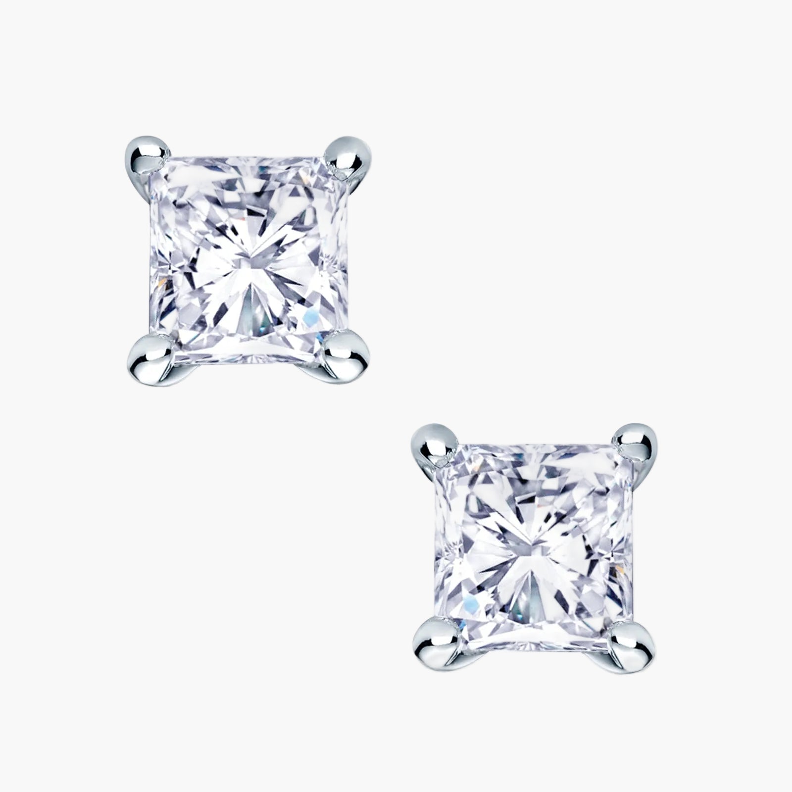 Pair of princess cut diamond stud earrings on a white background