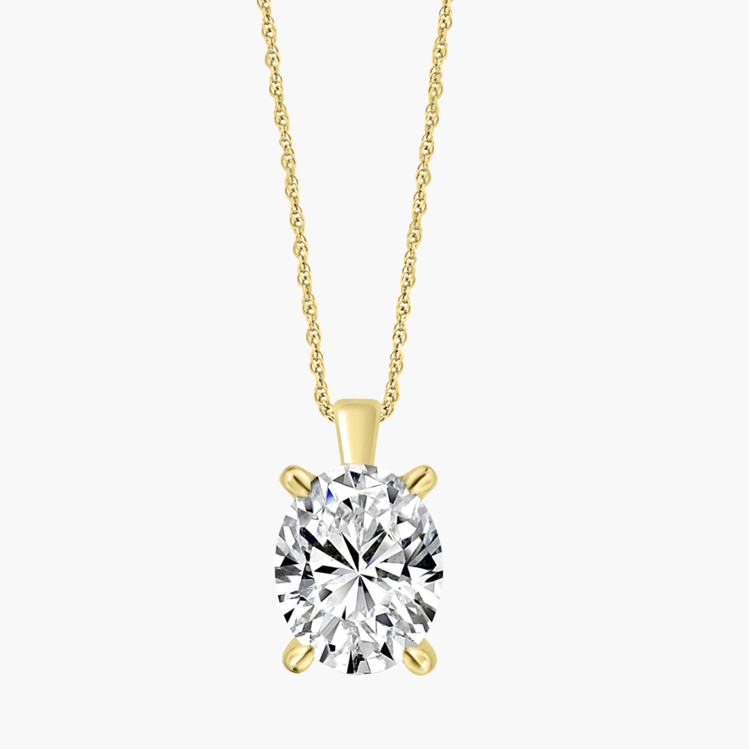 Gold necklace with a clear gemstone pendant on a white background