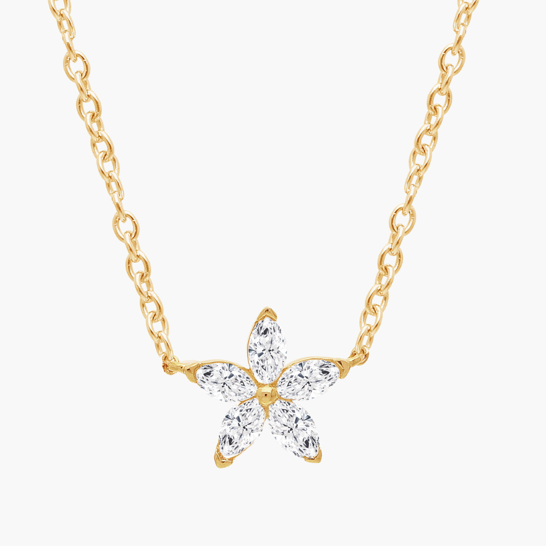 Gold butterfly necklace with clear gemstones on a white background