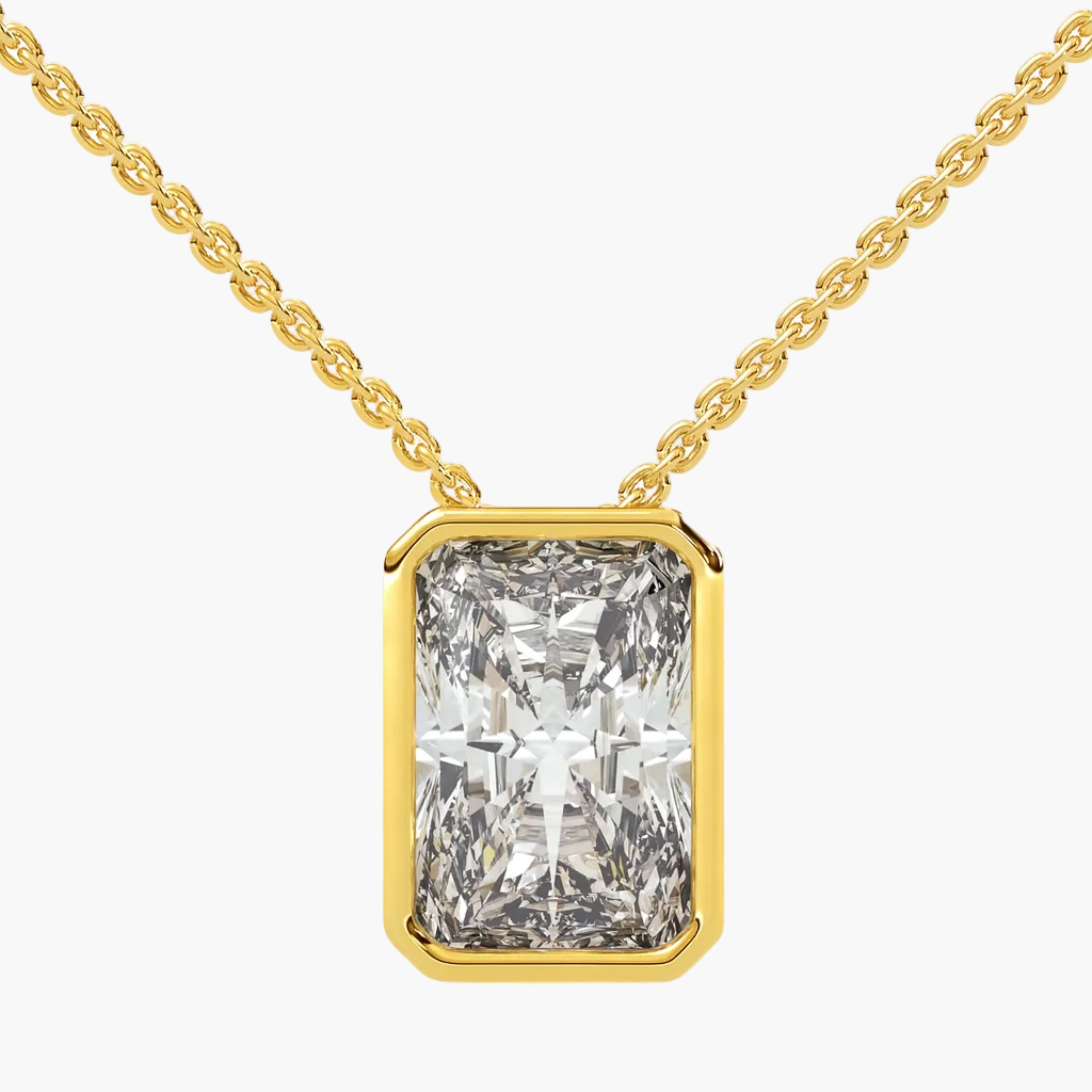 Gold necklace with a large diamond pendant on a white background