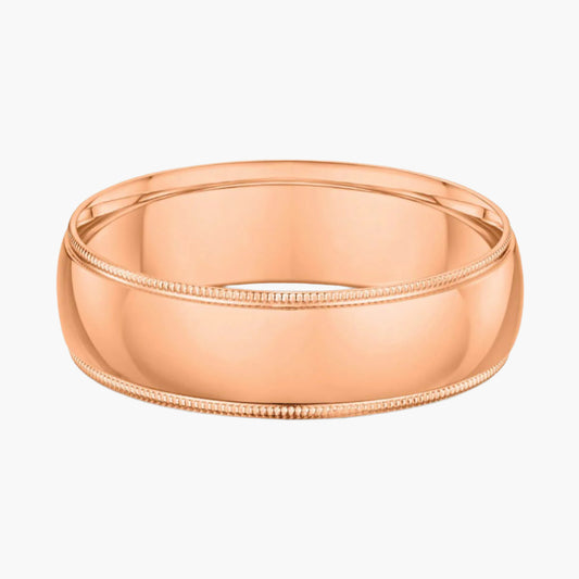 Rose gold ring with milgrain detailing on a white background