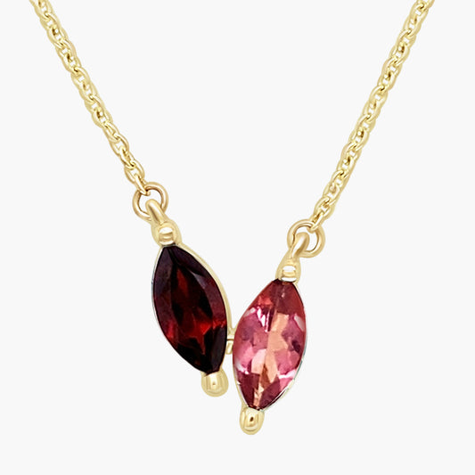 Gold necklace with two marquise-shaped gemstones on a white background