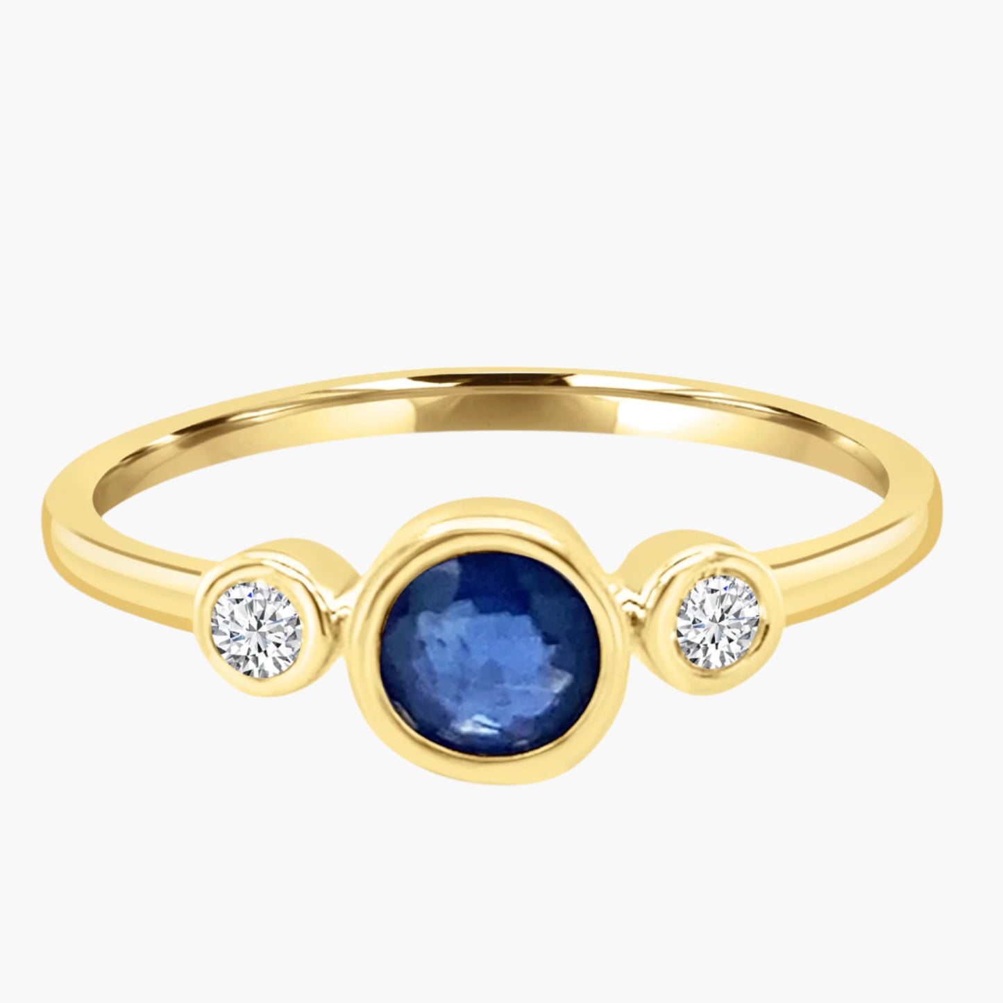 Gold ring with a blue gemstone and two diamonds on a white background