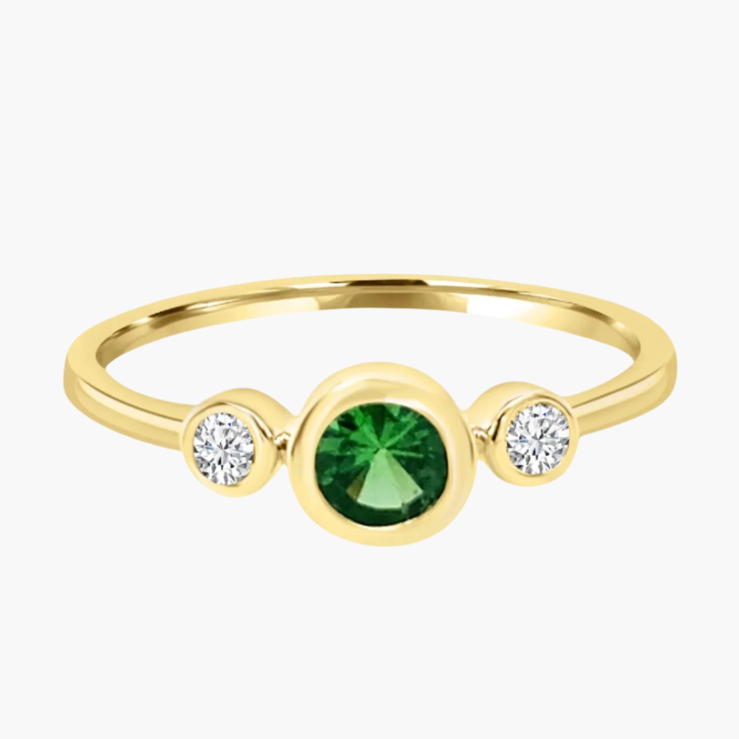 Gold ring with a green gemstone and two diamonds on a white background