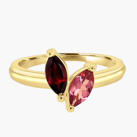 Gold ring with two red gemstones on a white background