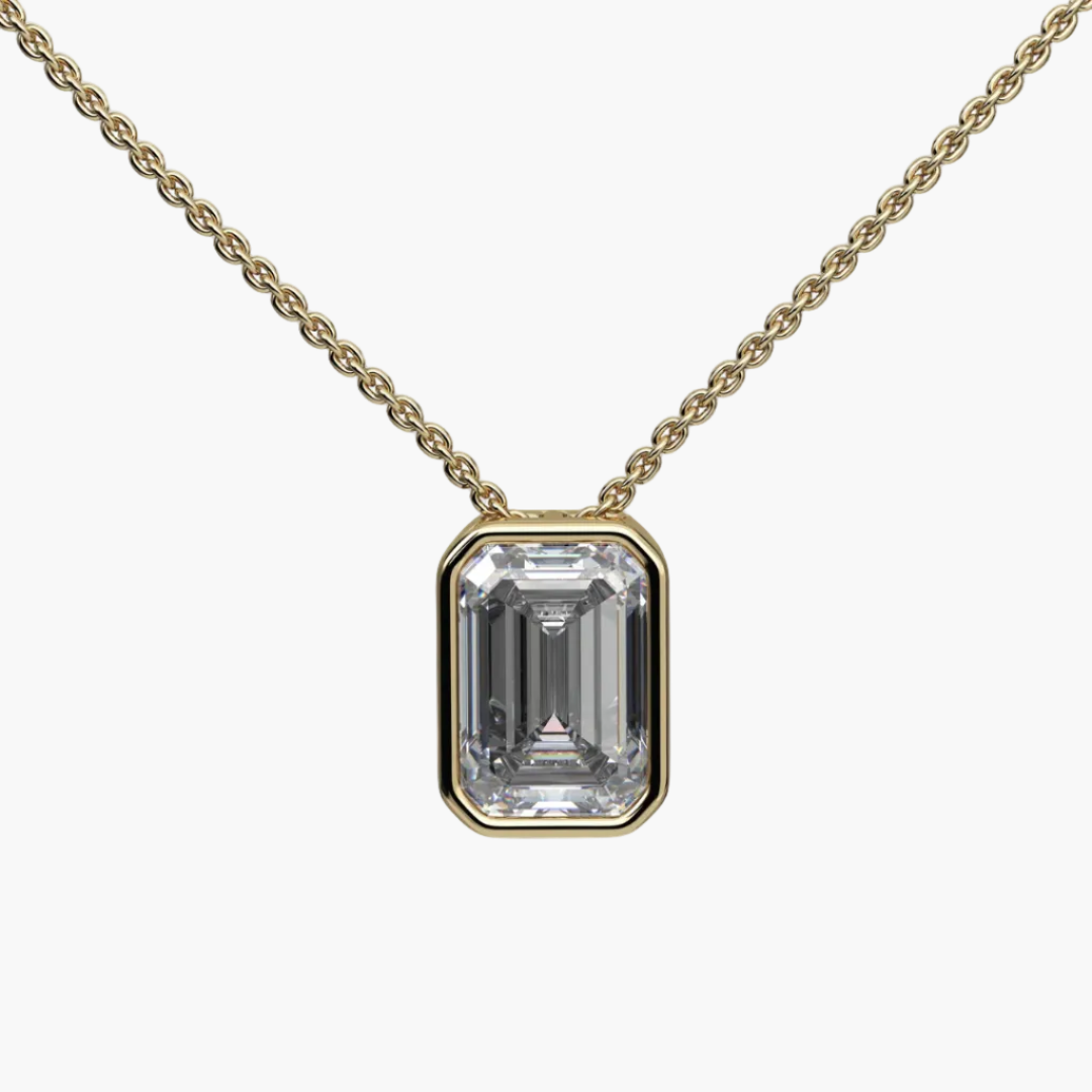 Gold necklace with a rectangular diamond pendant on a white background