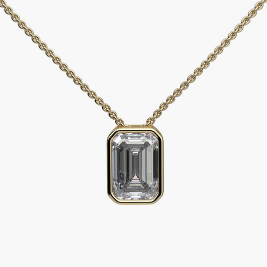 Gold necklace with a rectangular diamond pendant on a white background